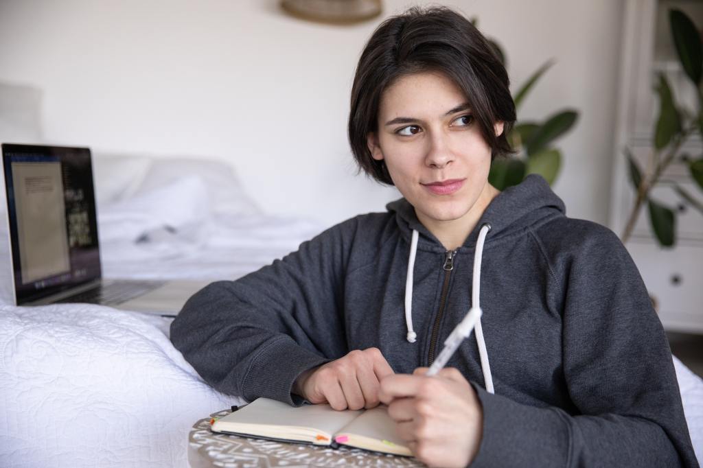 Woman sitting and journaling. 