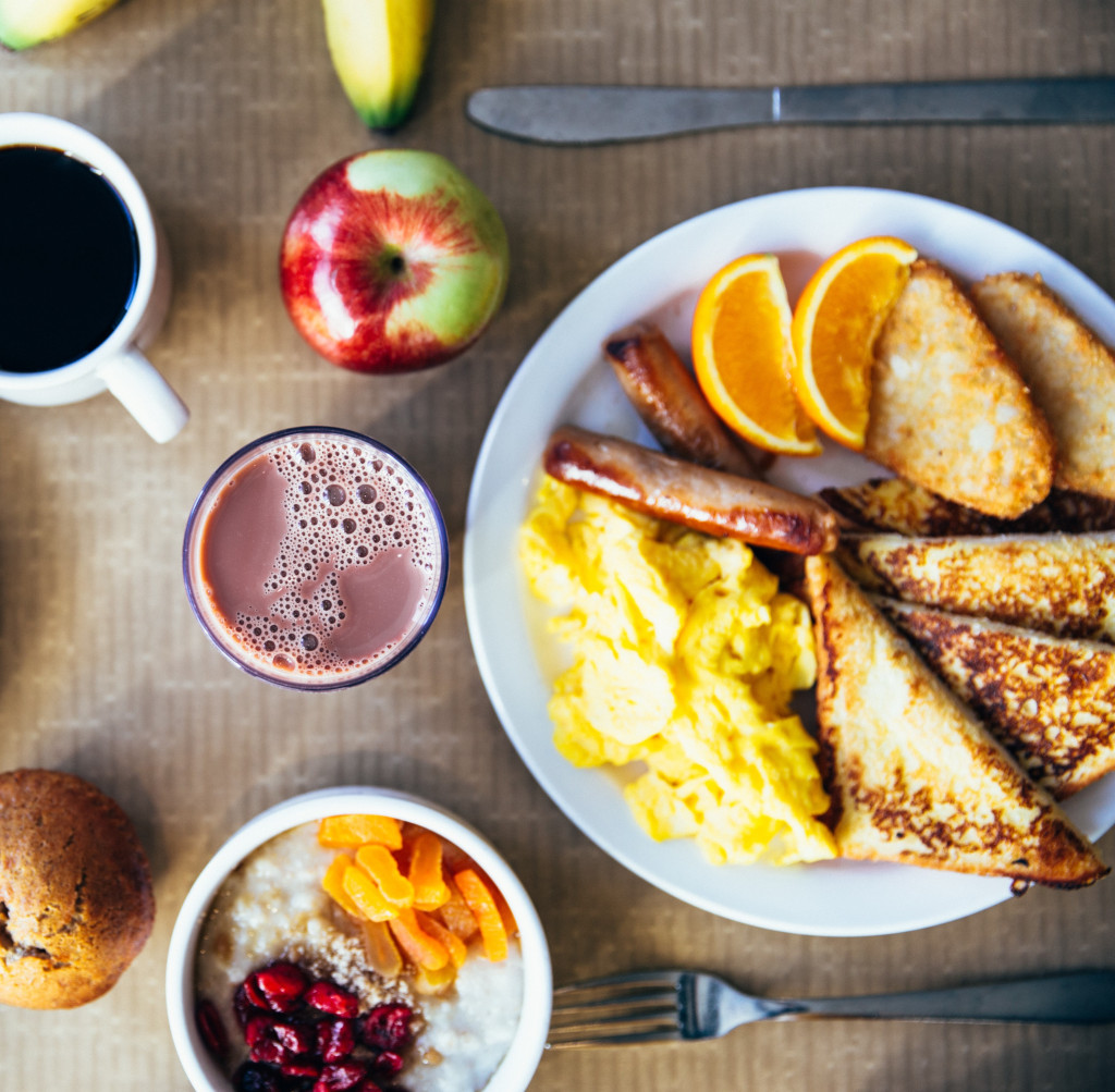 vegan breakfast foods, eggs, toast, sausage, fruit, juice, coffee