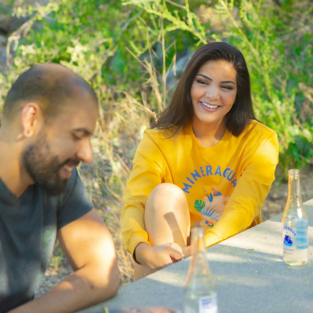 man and woman sitting at a park talking 