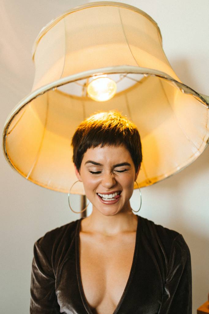 women under a lampshade smiling