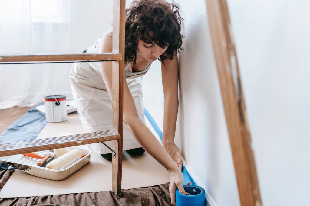 woman preparing the floor to paint 